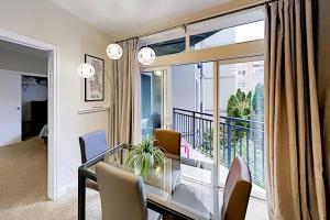 a dining room with a glass table and a balcony at Belltown Court III in Seattle