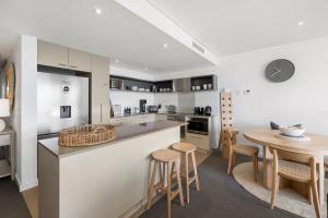 a kitchen and dining room with a table and chairs at Lorne Chalet Apartment 33 in Lorne