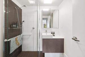 a bathroom with a shower and a sink at Lorne Chalet Apartment 33 in Lorne +6 photos