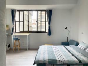 Postel nebo postele na pokoji v ubytování LeeHo B&B 李何寓所