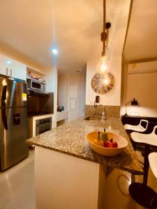 a kitchen with a bowl of fruit on a counter at MORROS EPIC luxury in Cartagena de Indias