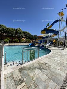 a swimming pool with a water slide at a theme park at DiRoma Fiori Caldas Novas - YMT - 323 in Caldas Novas