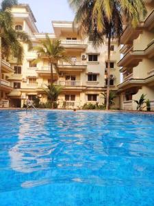 una gran piscina frente a un edificio en Seacoast Retreat- Lovely 2 BHK apartment with pool, en Varca