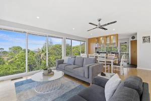 a living room with a couch and a table at Watonga Waves in Port Macquarie