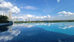 a swimming pool with a city in the background at Macrolink Medini @ UHA in Nusajaya