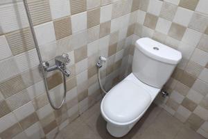 a bathroom with a toilet and a shower at RedDoorz Syariah near Alun Alun Purwokerto 2 in Purwokerto