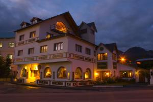 a large white building with an open window at Hosteria y Restaurante America in Ushuaia