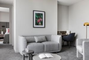 a living room filled with furniture and a painting on the wall at Oakwood Premier Melbourne in Melbourne