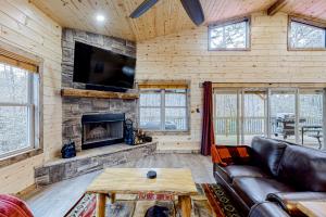 ein Wohnzimmer mit einem Sofa und einem Kamin in der Unterkunft Cozy Bear Cabin #1 in Sautee Nacoochee