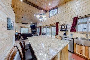 a kitchen with a large island in a log cabin at Cozy Bear Cabin #1 in Sautee Nacoochee