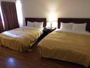 Postel nebo postele na pokoji v ubytování SunWang Hotel