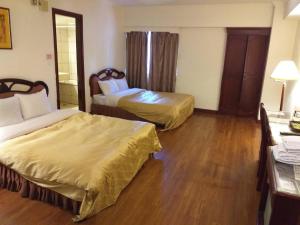 Postel nebo postele na pokoji v ubytování SunWang Hotel