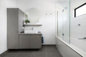 a bathroom with a sink and a mirror at Banksia Villa in Eganstown +5 photos