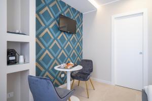 TV a/nebo společenská místnost v ubytování Il Pumo - Apulian Rooms Bari Calefati