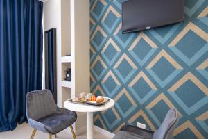 TV a/nebo společenská místnost v ubytování Il Pumo - Apulian Rooms Bari Calefati