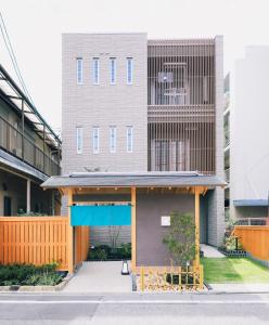 a building with a blue awning in front of it at LAZULI Hiroshima Hotel and Lounge in Hiroshima