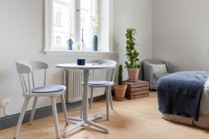 a room with a table and two chairs and a bed at Holterman Hostel in Gothenburg