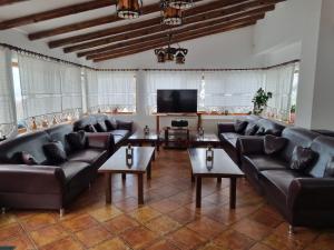 a living room with leather couches and a flat screen tv at Casa BonDia in Paraul Rece