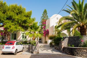 a small white car parked in front of a house at Joanna Villas in Kamari