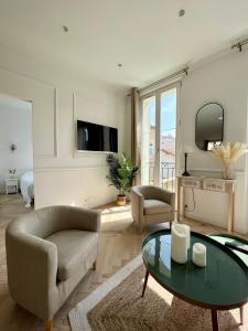 a living room with a couch and a table at amazing new property in the heart of the old town of antibes in Antibes