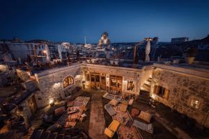 an aerial view of a building with a city at night at Doda Artisanal Cave Hotel - Adults Only - in Nevsehir