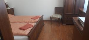 a small room with two beds and a chair at Ubytování pod Pálavou in Horní Věstonice
