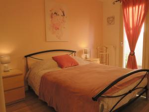 Schlafzimmer mit einem Bett und einem Fenster in der Unterkunft Chez Marielle in LʼIsle-sur-la-Sorgue