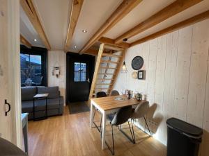 a room with a table and chairs and a ladder at Luxury Chalets Monnickendam in Monnickendam