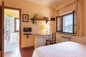 Postel nebo postele na pokoji v ubytování Antico Casale Di Scansano Resort + 37 fotografií