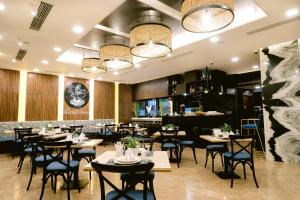 a restaurant with tables and chairs and a bar at Goldberry Suites and Hotel Cebu in Cebu City