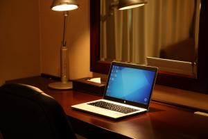 a laptop computer sitting on top of a desk at ANA Crowne Plaza Okayama by IHG in Okayama