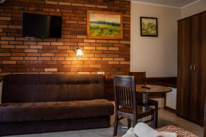 a living room with a couch and a table at URychertow in Kiełpino
