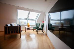 ein Wohnzimmer mit grünen Stühlen und einem Tisch in der Unterkunft Harbour View / Marina / City Centre in Tórshavn