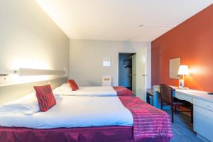 Postel nebo postele na pokoji v ubytování Hotel Ambiotel