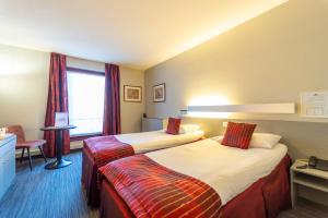 Postel nebo postele na pokoji v ubytování Hotel Ambiotel