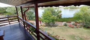 a balcony with a view of a river and a yard at Casa Victoria in Nufăru