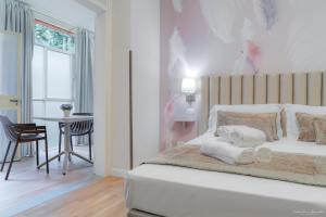 a bedroom with a bed with towels on it at Hotel Cosmos in Florence