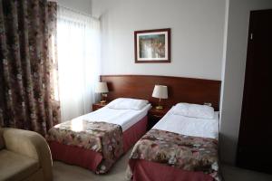 
Łóżko lub łóżka w pokoju w obiekcie Aparthotel Ekspresja
