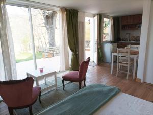 a living room with a bed and chairs and a table at 1001 Ocres in Apt