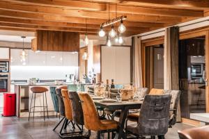 a dining room with a table and chairs at Chalet Galibier in Saint-Chaffrey