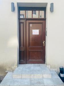 a brown door on the side of a building at Angel Apartment Taczaka in Poznań