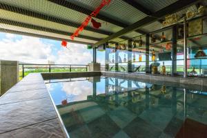 a swimming pool in a building with a view of the sky at Emilia Villa in Hengchun
