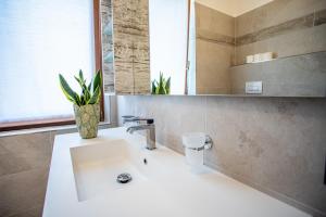 a bathroom with a white sink and a mirror at Hotel Residence La Pertica in Tremosine Sul Garda +82 photos