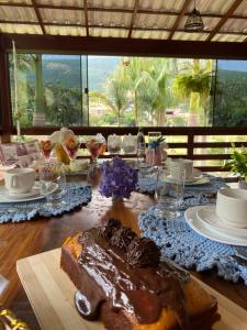 a table with a piece of cake on top of it at Pousada Rancho na Serra in Espera Feliz