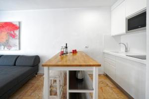 a small kitchen with a wooden table in a room at Vista Bonita - Gay and Lesbian Only Resort in Maspalomas