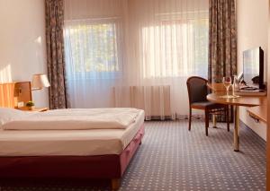Postel nebo postele na pokoji v ubytování Akzent Congresshotel Hoyerswerda