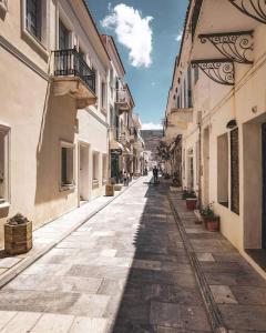 an empty street in a town with buildings at Liopi Village Andros in Órmos