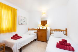 two beds in a room with red towels on them at CASA GOLF beautiful views with private pool in San Miguel de Abona +28 photos