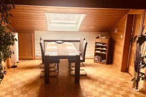 a dining room with a table and two chairs at 2-Zimmer DG-Apartment mit eigener Sauna in Oberhaching
