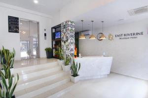 a lobby of an office with potted plants at East Riverine Boutique Hotel in Kuala Lumpur